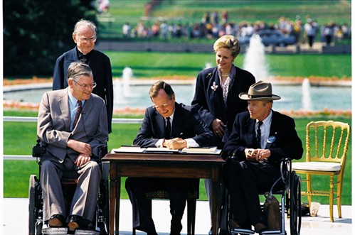President George H.W. Bush signs the Americans with Disabilities Act into Law 1990 Courtesy Wikimedia