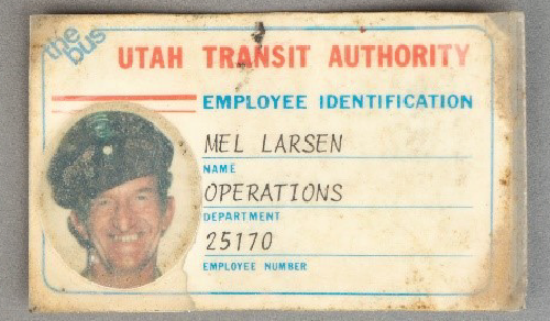 A dated employee identification card for "Mel Larson" who worked for the Utah Transit Authority.